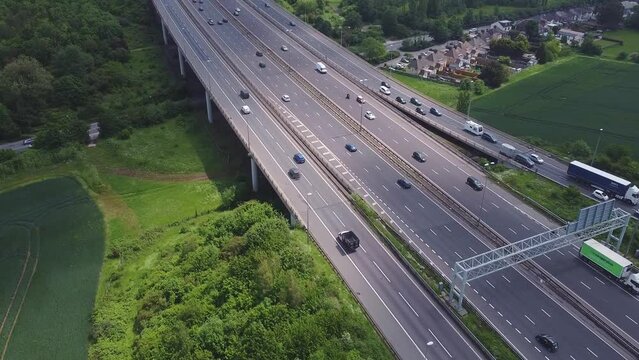 Aerial drone footage of traffic on a motorway in England. A2 - M25 Darenth Interchange in Kent, leading to Dover, London, Queen Elizabeth II bridge and Essex, UK.