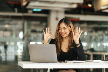 Asian beautiful woman smiling using computer laptop typing innovative ideas, in video call conference meetings with collogues discussing work planning strategy ecommerce during quarantines isolation