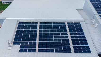 Fototapeta premium Solar power panels on the roof for green energy. Solar panels on factory roof photovoltaic solar panels absorb sunlight.