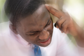 Dizzy African man office worker suffering from headache, vertigo, dizziness, stress