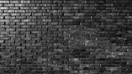 Dark black brick wall texture of stonewall. Bricks from stones and cement lines, Rough brick wall, brickwork background for design.