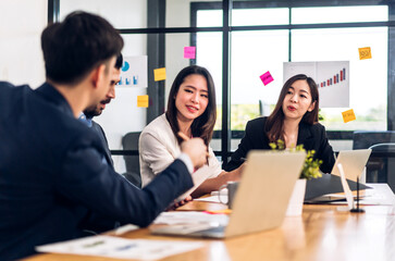 Group of asian business meeting and discussing strategy startup project analysis finance process.Success business people work plan and brainstorm marketing idea with laptop in office.Teamwork