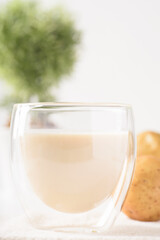 Potato milk in a glass, a healthy plant based drink on white background