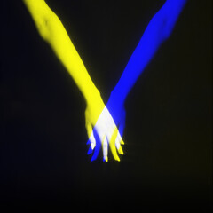 Abstract background concept. Two crossed arms in blue and yellow colors split effect. Holding slim woman hands. Transparent, glow and illusion effect. studio shot on black background with copy space