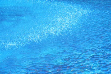 Fototapeta na wymiar 爽快な水しぶき　全面ライトブルーの背景