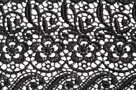 Black lace on white background. Close up