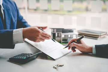 Real estate agents present and consult with clients to decide whether to sign an insurance...