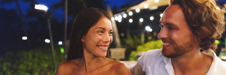 Dating couple in love on online first date at bar on night out banner panoramic. Asian woman, Caucasian man having fun laughing smiling, biracial relationship young people
