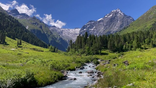 Melach river in the beautiful Lüsens valley in Austria with high mountains and blue sky in the background
