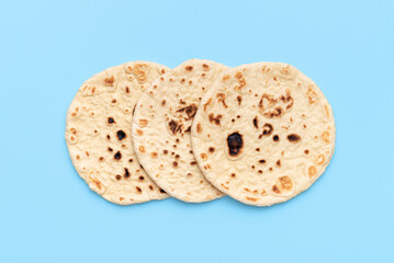 Indian flatbreads on a blue background, above view. Homemade naan bread