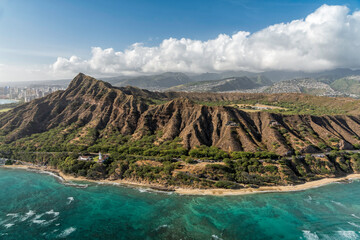 Helicopter view of Diamond Head Mountain , volcanic tuff cone and city buildings in background,...