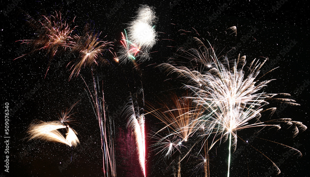 Wall mural row of different fireworks in front of starry sky