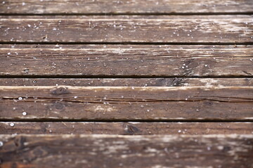 Obraz premium Wet wooden laths covered with some hailstones
