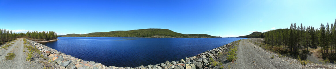 Fototapeta na wymiar Panoramic view over lake in Sweden, seen from a gravel dam