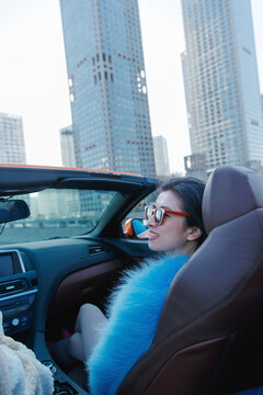 The fashionable young woman sitting in the co-pilot for a ride