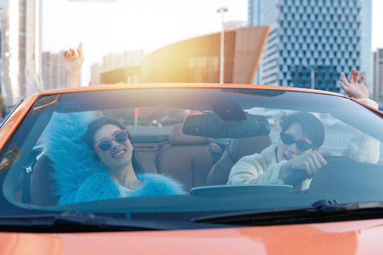 Fashionable young couples driving car travel