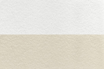 Texture of craft beige and white paper background, half two colors, macro. Structure of vintage brown cardboard