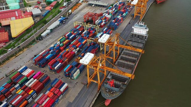 Time lapse view of container cargo ship in the export, import business, logistics and transportation. International goods in urban city. Shipping to the harbor by crane in Bangkok City, Thailand