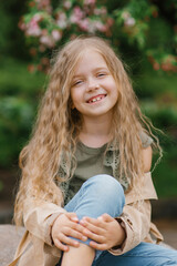 Obraz premium Portrait of a happy smiling toothy seven-year-old girl with long brown hair