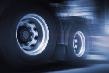 Spinning Truck Wheels. Speed of Semi Trucks Driving on the Road. Diesel Truck. Freight Truck Logistics Transport .