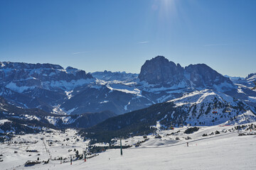 Beautiful Val Gardena in the Dolomites, view of Sella mountain from Seceda. Ski slopes to Santa Christina and Selva in the South Tyrol. Winter landscape covered in Snow
