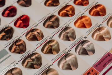 Samples of professional hair dye in a hairdressing salon. Hair coloring in a beauty salon. Hair dye...
