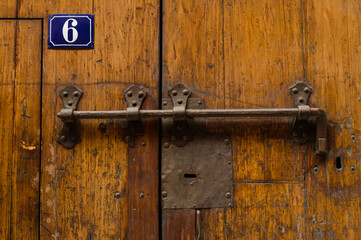 Massive old rusty iron lock on wooden door