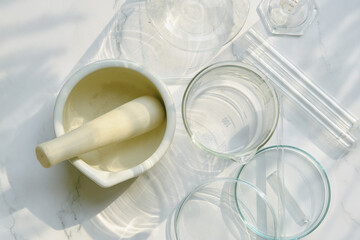 Alternative herbal medicine, Mortar with healing botanical herbs, Natural organic botany and scientific glassware, Natural skin care beauty products.