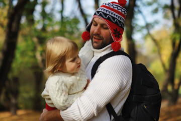 Fototapeta premium Children for a walk in the autumn park. Leaf fall in the park. Family. Fall. Happiness.