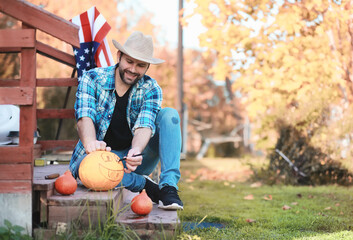 Autumn traditions and preparations for the holiday Halloween. A house in nature, a lamp made of pumpkins is cutting out at the table.