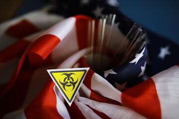 American flag and biohazard sign. The concept of American biolabs and research centers.