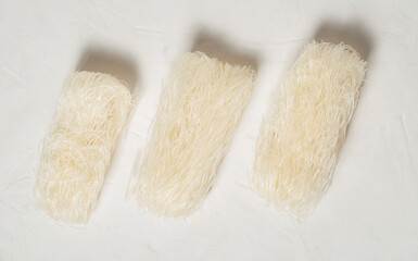 raw Korean starch noodles tanmen on a gray background, top view.