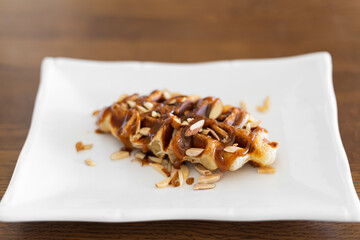 Caramel croffle and sprinkled with almonds