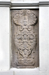 Stone bas-relief with women's dancers on wall of Sri Dalada Maligawa, Kandy, Sri Lanka