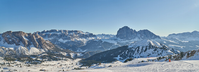 Beautiful Winter Landscape in the Val Gardena. Sassolungo Mountain in the background. Wide Winter Landscape