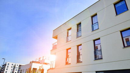 Apartment residential house and home facade architecture and outdoor facilities. Blue sky on the background. Sunlight in sunrise.