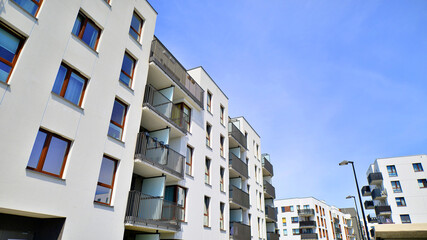 Apartment residential house and home facade architecture and outdoor facilities. Blue sky on the background. Sunlight in sunrise.