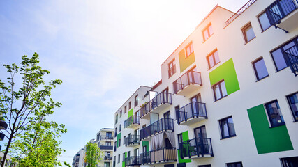 Apartment residential house and home facade architecture and outdoor facilities. Blue sky on the background. Sunlight in sunrise.