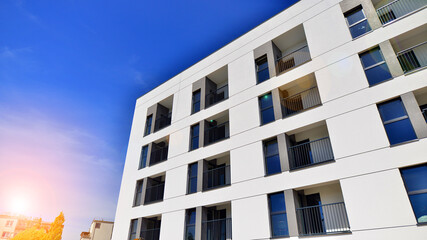 Apartment residential house and home facade architecture and outdoor facilities. Blue sky on the background. Sunlight in sunrise.