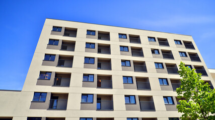 Fototapeta premium Apartment residential house and home facade architecture and outdoor facilities. Blue sky on the background. Sunlight in sunrise.