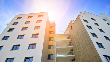 Apartment residential house and home facade architecture and outdoor facilities. Blue sky on the background. Sunlight in sunrise.