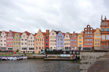Fototapeta na wymiar Historic Old Town of Gdansk in Poland, colourful houses on embankment in rainy weather.