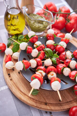 Caprese salad - Mini mozzarella cheese in glass bowl, tomato and basil