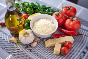 Grated parmesan cheese on a wooden cutting board at domestic kitchen