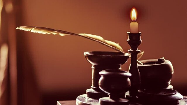 Feather quill pen on candlelit writing desk in dark orange red room Cinemagraph