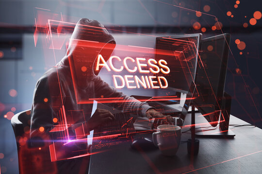 Side view of hacker using computers at desktop with abstract red denied access hologram on blurry office interior background. Connection and crime concept. Double exposure.