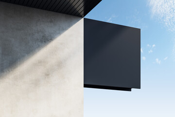 Empty black square stopper or banner hanging on concrete building with shadows and bright blue sky view. Bar, restaurant, shop and advertisement concept. Mock up, 3D Rendering.