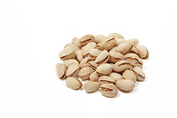 Pile of pistachios isolated on white background. Closeup of pistachios in the peel