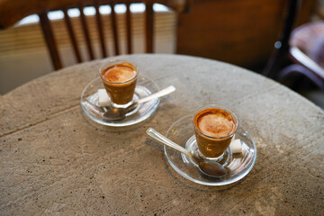 Two cups of coffee on cocnrete table in the cafe