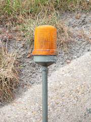 Orange warning light on a pole